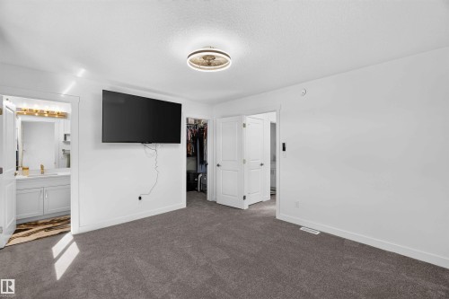 Plush carpeted flooring with a modern ceiling fixture - 91 Hilton Cove, Spruce Grove, AB - Indoor Photo Showing Other Room