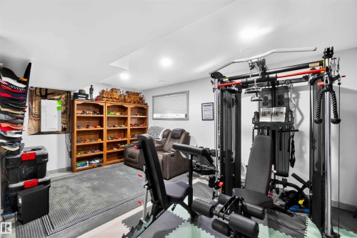 Recessed lighting throughout, wood-finish shelving, and a window with blinds - 91 Hilton Cove, Spruce Grove, AB - Indoor Photo Showing Gym Room