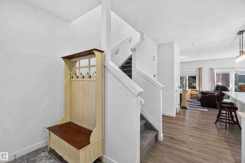 Wood-finish flooring throughout the main level - 91 Hilton Cove, Spruce Grove, AB - Indoor Photo Showing Other Room