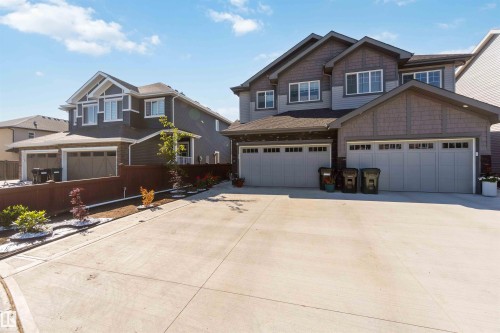 Modern exterior featuring siding and shingle accents, multiple windows, and attached garages - 91 Hilton Cove, Spruce Grove, AB - Outdoor With Facade