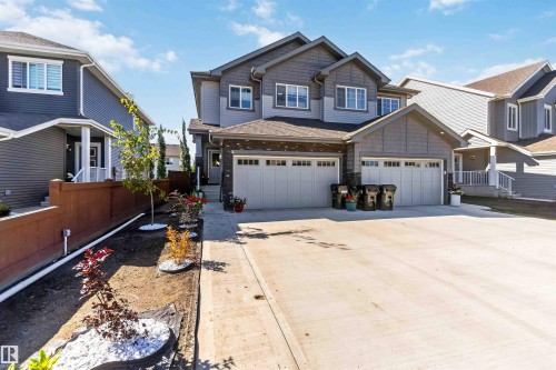 Contemporary two-story exterior with multi-toned siding and brick accents - 91 Hilton Cove, Spruce Grove, AB - Outdoor With Facade
