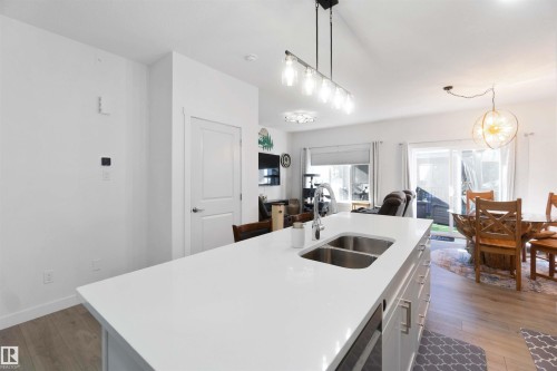 Kitchen island with a dual basin undermount sink and gooseneck faucet - 91 Hilton Cove, Spruce Grove, AB - Indoor Photo Showing Kitchen With Double Sink