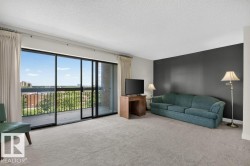 Living area featuring expansive sliding glass doors opening to a private balcony - 