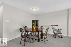 Neutral-toned room featuring a light-colored wall finish, white baseboards, and textured ceiling - 