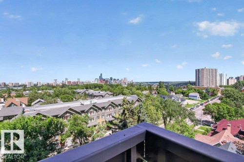 Expansive cityscape featuring a distant skyline, verdant tree canopy, and residential rooftops - #804 11027 87 Av Nw, Edmonton, AB - Outdoor