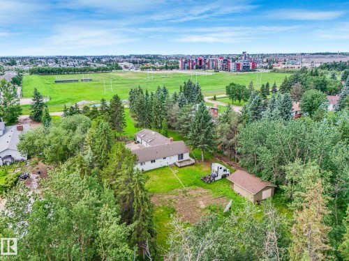 Expansive residential property set on wooded acreage with mature evergreen and deciduous trees throughout - 10912 5 Avenue Sw, Edmonton, AB - Outdoor With View