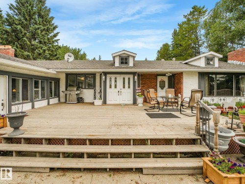 Expansive wood deck with multiple steps and white double entry doors - 10912 5 Avenue Sw, Edmonton, AB - Outdoor With Deck Patio Veranda