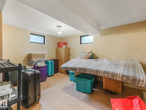 Recessed windows, exposed ceiling beams, recessed ceiling light fixture, tile flooring, painted walls - 10912 5 Avenue Sw, Edmonton, AB - Indoor
