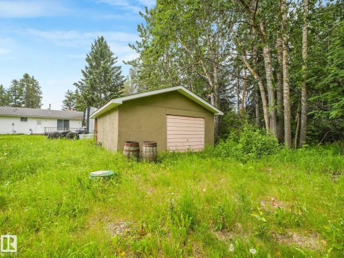 Detached shed with stucco exterior and roll-up door - 10912 5 Avenue Sw, Edmonton, AB - Outdoor