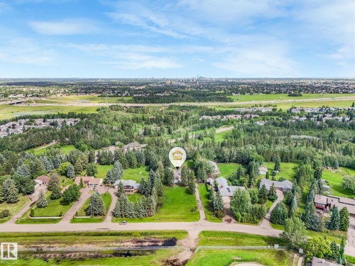 Expansive lot featuring mature trees, a broad lawn, and a paved driveway - 10912 5 Avenue Sw, Edmonton, AB - Outdoor With View