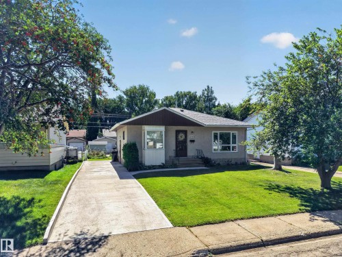 Ranch-style residence featuring a stucco exterior and an asphalt shingle roof - 5207 48 Avenue, Leduc, AB - Outdoor