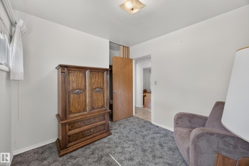 Wall-to-wall carpeting in a neutral tone and a flush-mount ceiling light fixture - 5207 48 Avenue, Leduc, AB - Indoor Photo Showing Other Room