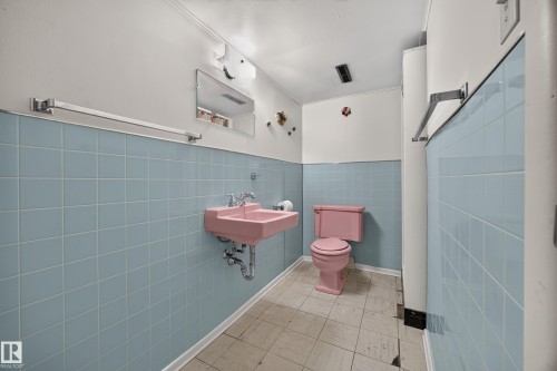 Tile flooring with light blue wall tiling - 5207 48 Avenue, Leduc, AB - Indoor Photo Showing Bathroom