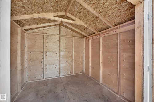 Plywood wall construction with exposed wood framing, wood-finish flooring, and roof with exposed wood trusses - 5207 48 Avenue, Leduc, AB - Indoor Photo Showing Other Room