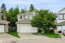 Two-story residence with light-toned siding, attached garage, and a gabled roofline - 1720 Robertson Place Sw, Edmonton, AB  - Outdoor 