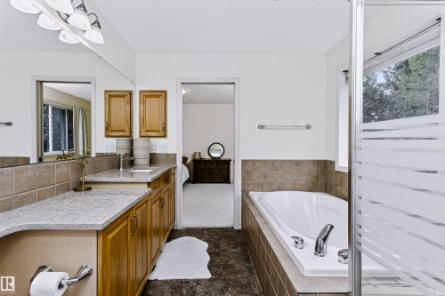 Vanity with light-toned wood cabinetry and a light-colored countertop - 1720 Robertson Place Sw, Edmonton, AB - Indoor Photo Showing Bathroom