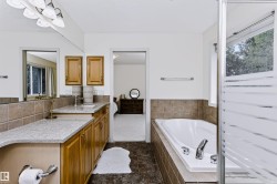 Vanity with light-toned wood cabinetry and a light-colored countertop - 