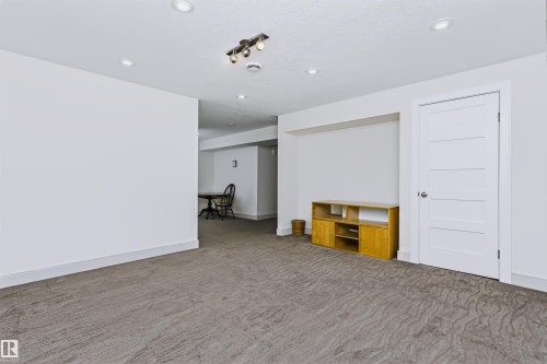 Recessed lighting, track lighting fixture, built-in wall niche, and panel interior door - 1720 Robertson Place Sw, Edmonton, AB - Indoor Photo Showing Other Room