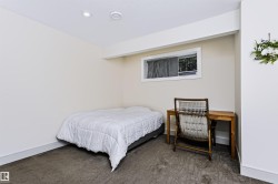 Recessed lighting fixtures, broadloom carpet, and a white window frame with a horizontal blind - 