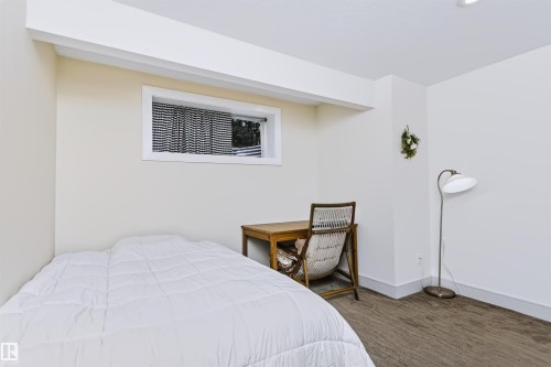 Recessed lighting and a window with white trim - 1720 Robertson Place Sw, Edmonton, AB - Indoor Photo Showing Bedroom