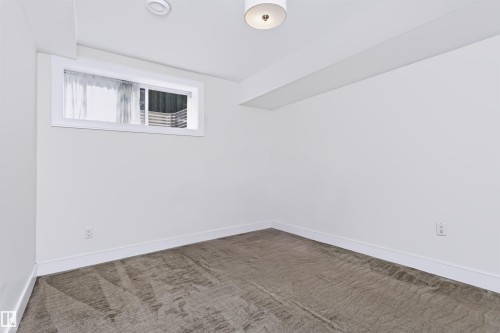 White painted walls, carpeted flooring, and a recessed window - 1720 Robertson Place Sw, Edmonton, AB - Indoor Photo Showing Other Room