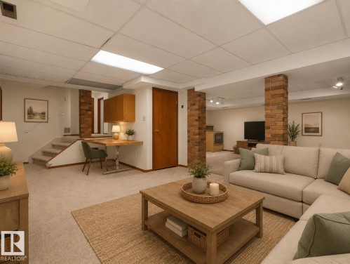 Carpeted lower level featuring brick-faced structural columns, recessed lighting, and a built-in wood-finish desk with upper cabinetry - 7357 18 Avenue Nw, Edmonton, AB - Indoor