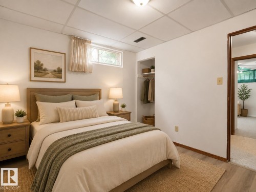 Recessed window with decorative grilles, built-in open closet with shelving and hanging rod, wood-finish flooring, and a drop ceiling - 7357 18 Avenue Nw, Edmonton, AB - Indoor Photo Showing Bedroom
