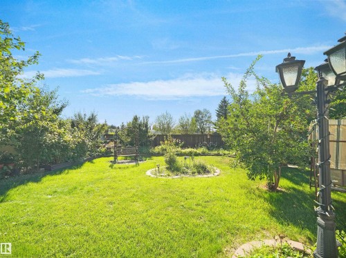 Expansive grassy yard with mature trees and a decorative lamp post - 7357 18 Avenue Nw, Edmonton, AB - Outdoor With View