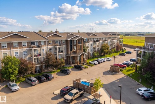 Multi-story residential building with private balconies and exterior parking - #2415 9357 Simpson Dr Nw, Edmonton, AB - Outdoor