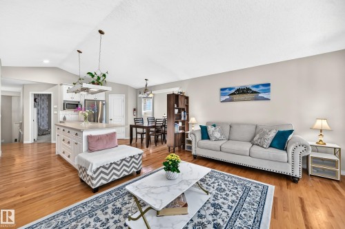 Vaulted ceilings with recessed lighting, wood-finish flooring, and light-toned wall paint - 4210 37 Avenue Nw, Edmonton, AB - Indoor Photo Showing Living Room