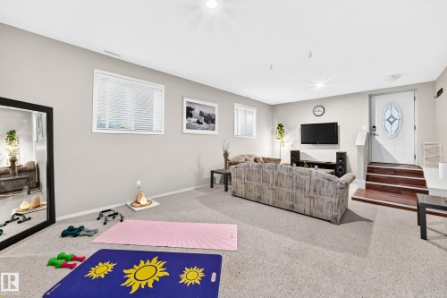 Recessed lighting illuminates this room featuring light gray walls, two windows with white blinds, and light-toned carpeting - 4210 37 Avenue Nw, Edmonton, AB - Indoor