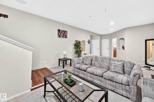Neutral wall paint, recessed lighting, arched doorway, and wood-finish flooring - 4210 37 Avenue Nw, Edmonton, AB - Indoor Photo Showing Living Room