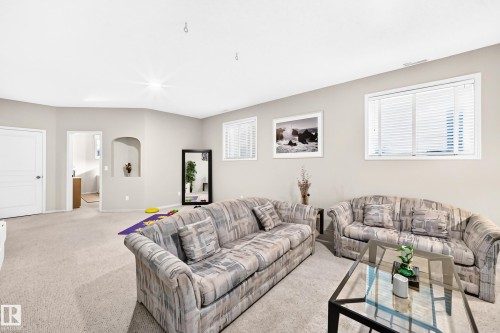 Recessed wall niche, white trim window, light gray wall paint, white interior doors, and neutral carpeting - 4210 37 Avenue Nw, Edmonton, AB - Indoor Photo Showing Living Room