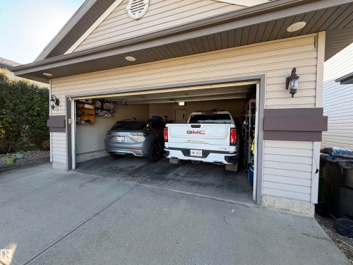 Attached two-car garage featuring a concrete driveway and vinyl siding - 4210 37 Avenue Nw, Edmonton, AB - Outdoor With Exterior