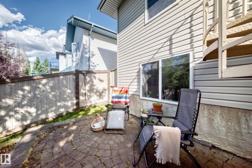 Paved patio area, privacy fencing, spiral staircase access, and exterior siding - 4210 37 Avenue Nw, Edmonton, AB - Outdoor