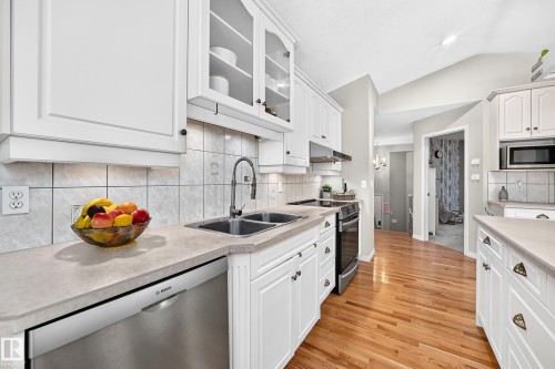 Kitchen with white cabinetry, light countertops, and a tile backsplash - 4210 37 Avenue Nw, Edmonton, AB - Indoor Photo Showing Kitchen With Double Sink With Upgraded Kitchen
