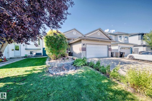 Single-story property with an attached two-car garage, concrete driveway, and a front lawn with mature landscaping - 4210 37 Avenue Nw, Edmonton, AB - Outdoor
