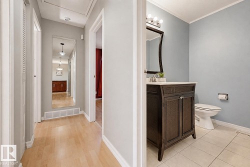 Wood-finish flooring with a full-length mirror - 6768 39 Avenue Nw, Edmonton, AB - Indoor Photo Showing Bathroom