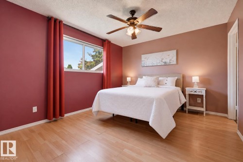 Wood-finish flooring - 6768 39 Avenue Nw, Edmonton, AB - Indoor Photo Showing Bedroom