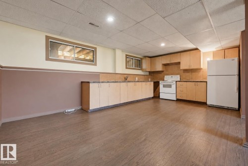 Wood-finish flooring with a drop ceiling, complete with recessed lighting - 6768 39 Avenue Nw, Edmonton, AB - Indoor Photo Showing Kitchen