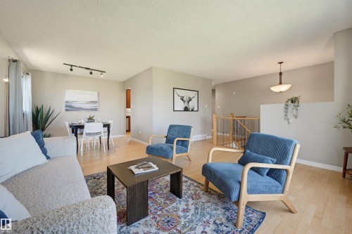 Hardwood-style flooring throughout - 6768 39 Avenue Nw, Edmonton, AB - Indoor Photo Showing Living Room