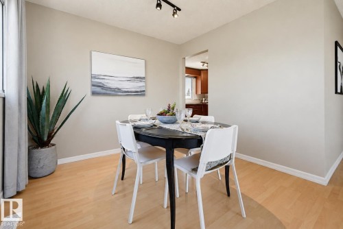 Light wood-finish flooring with neutral wall tones - 6768 39 Avenue Nw, Edmonton, AB - Indoor Photo Showing Dining Room