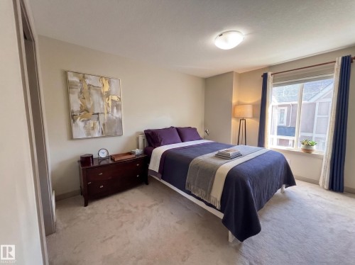 Wall-to-wall carpeting and a ceiling-mounted light fixture - #29 1150 Windermere Wy Sw, Edmonton, AB 