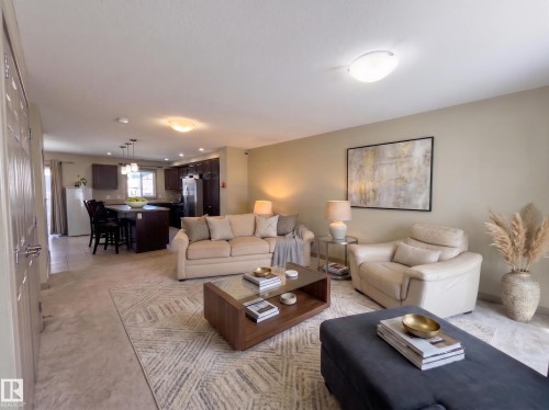Open-concept living space with light-toned walls - #29 1150 Windermere Wy Sw, Edmonton, AB 