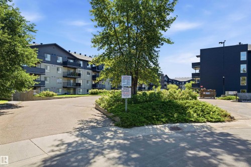 Contemporary multi-story building featuring balconies and dark-framed windows - #117 17011 67 Av Nw, Edmonton, AB - Outdoor