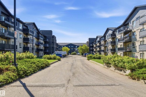 Multi-story buildings with balconies and sloped roofs - #117 17011 67 Av Nw, Edmonton, AB - Outdoor With Facade