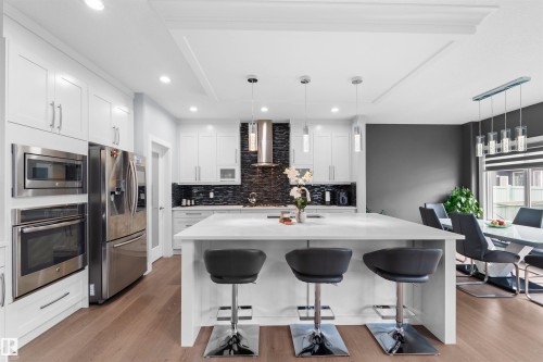 White cabinetry and stainless steel appliances - 16327 17 Avenue Sw, Edmonton, AB 