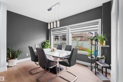 Wood-finish flooring, white trim, and dark accent walls - 