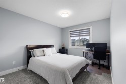 Light gray wall color, textured ceiling, flush mount ceiling light, white window trim, grey window blinds - 