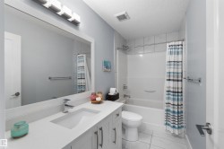 White vanity with an integrated sink, polished chrome faucet, and under-cabinet storage - 